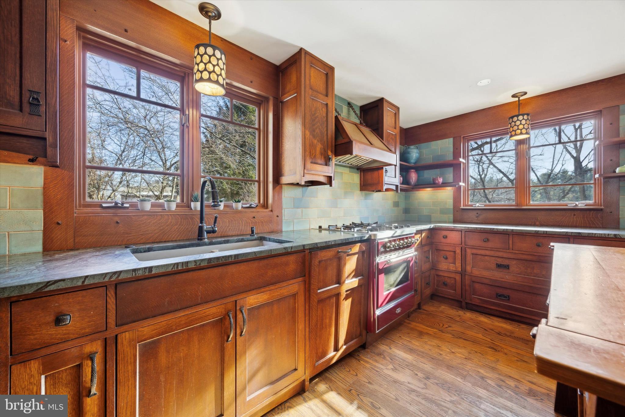 1991 Swedesford Road Malvern, PA 19355 - Photo 11 of 67 a kitchen with stainless steel appliances granite countertop wooden cabinets a sink and a large window