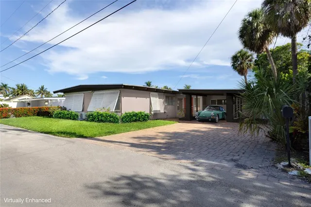 a front view of a house with a yard and a garage