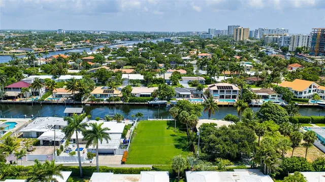an aerial view of lake and residential houses with outdoor space