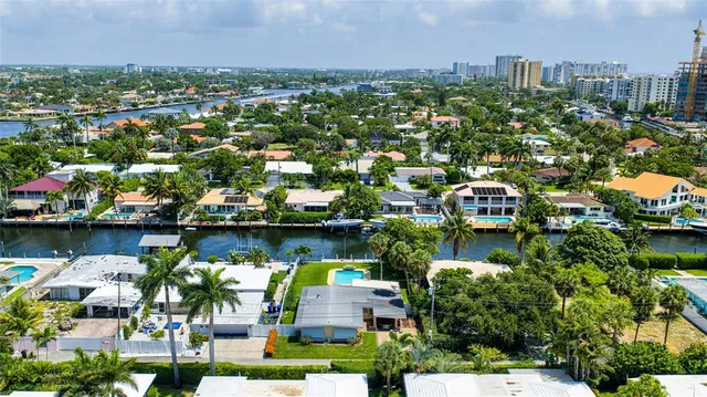 an aerial view of a city with lots of residential buildings lake and ocean view