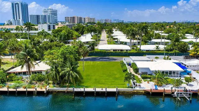 a view of a city with lawn chairs under an umbrella