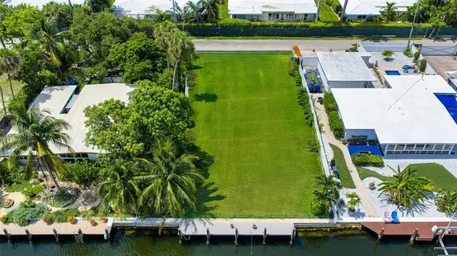an aerial view of a house with a garden and lake view