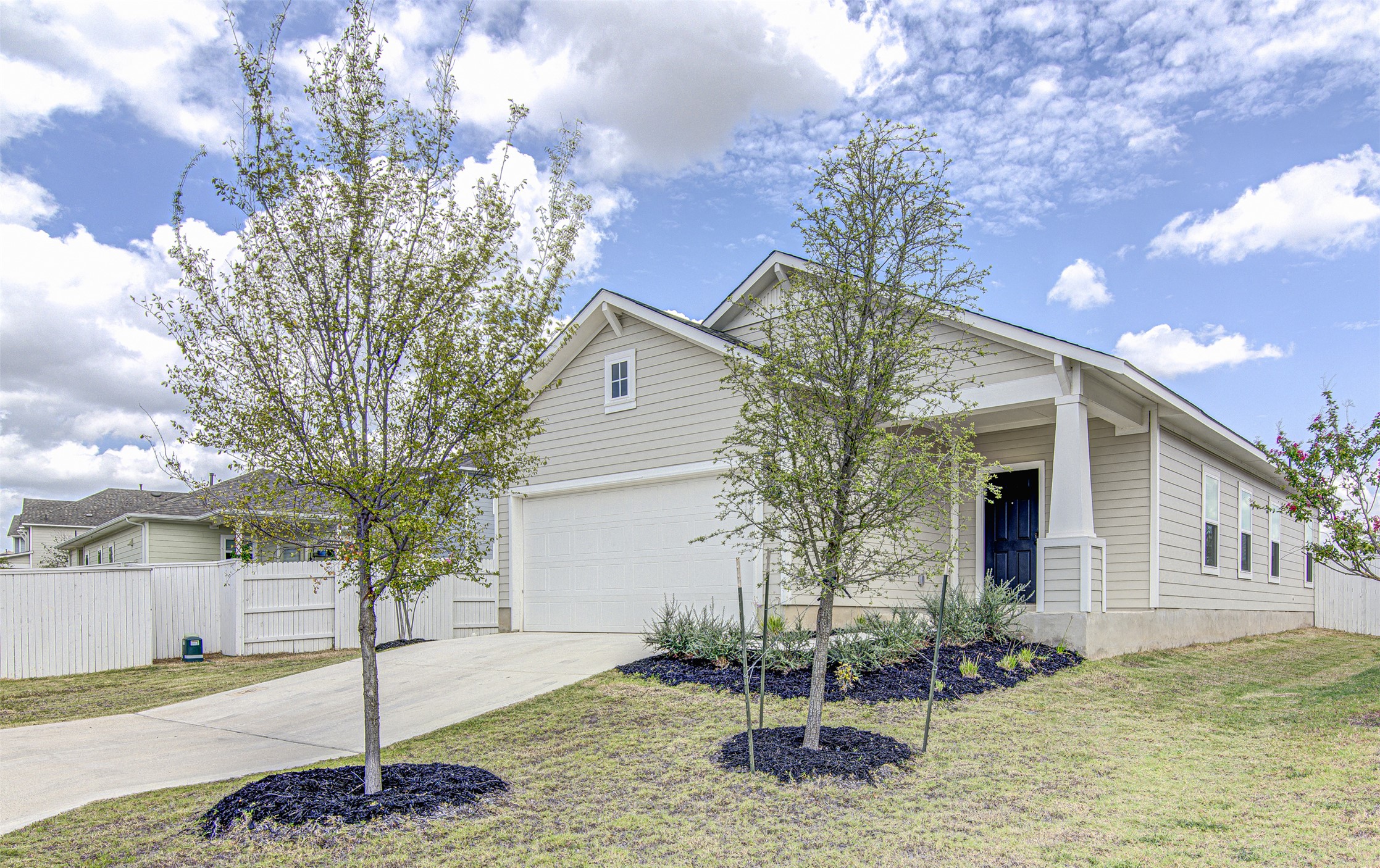 156 Tillage Road Elgin, TX 78621 - Photo 3 of 25 A welcoming facade with a covered porch and an integrated garage awaits you.