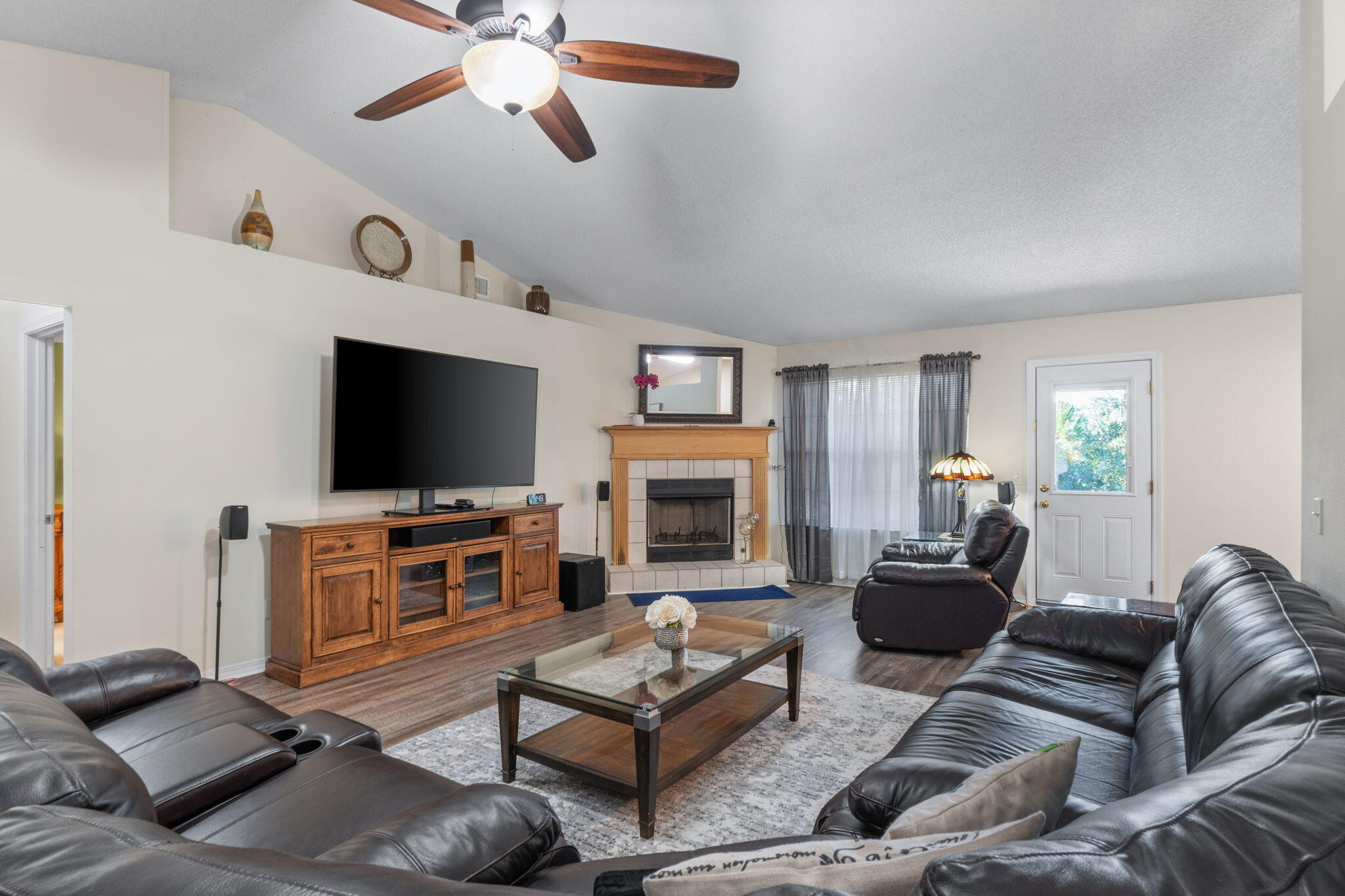 7036 Rampart Way Pensacola, FL 32505 - Photo 12 of 39 a living room with furniture a flat screen tv and a fireplace