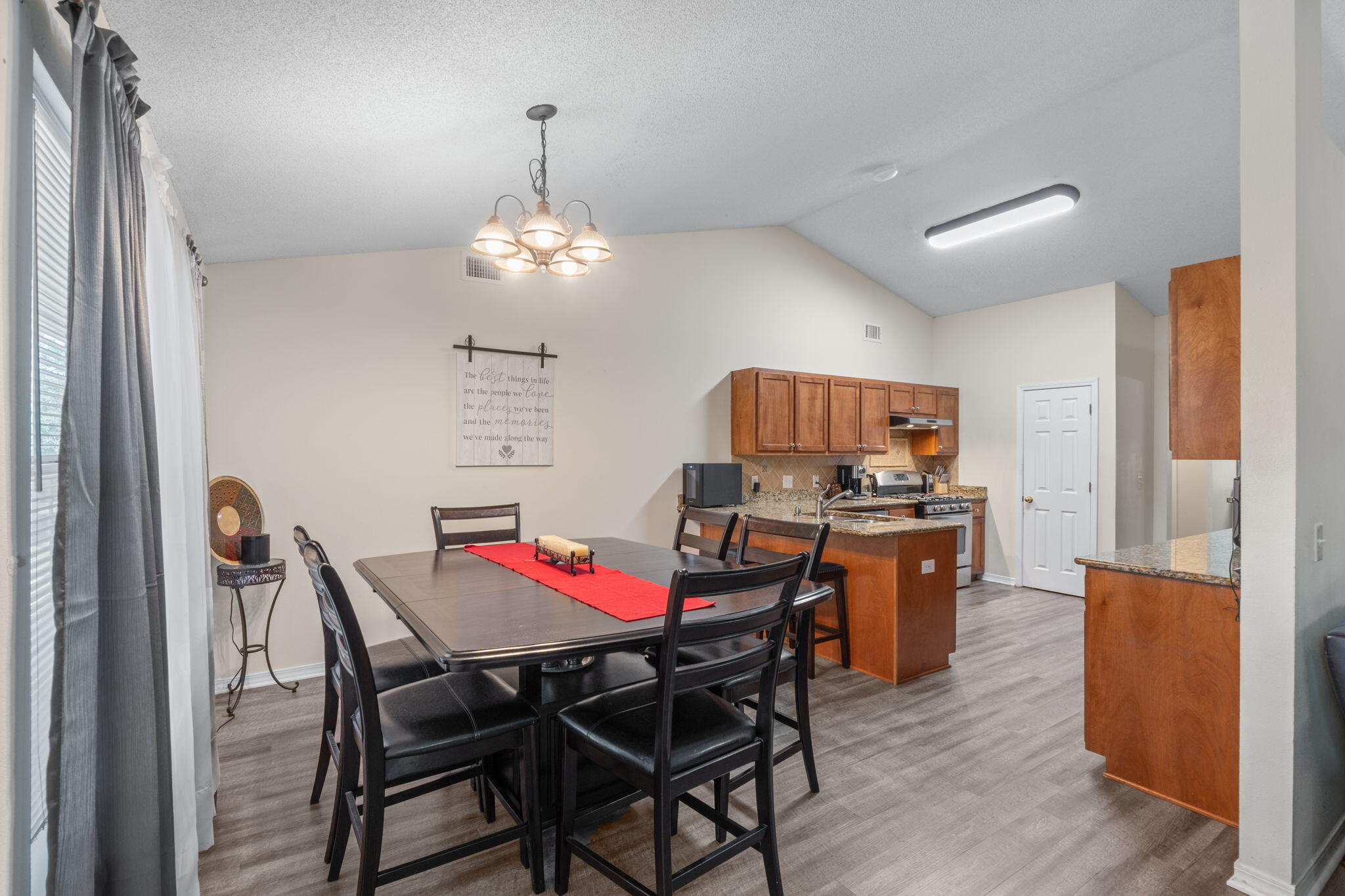 7036 Rampart Way Pensacola, FL 32505 - Photo 13 of 39 a view of a dining room with furniture and wooden floor