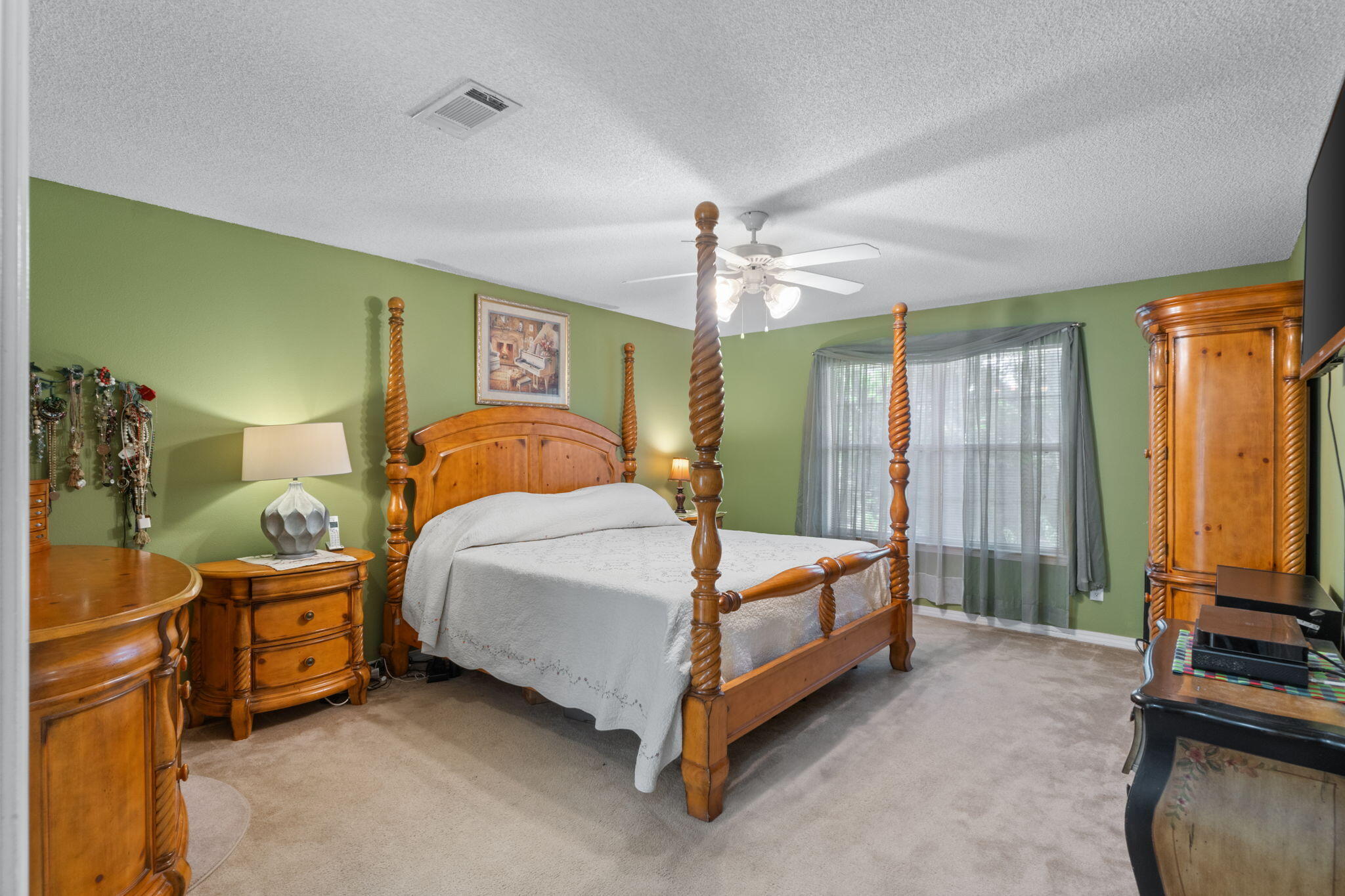 7036 Rampart Way Pensacola, FL 32505 - Photo 17 of 39 a spacious bedroom with a bed and a chandelier