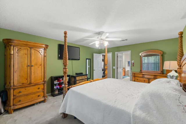 a bedroom with a bed dresser and a window