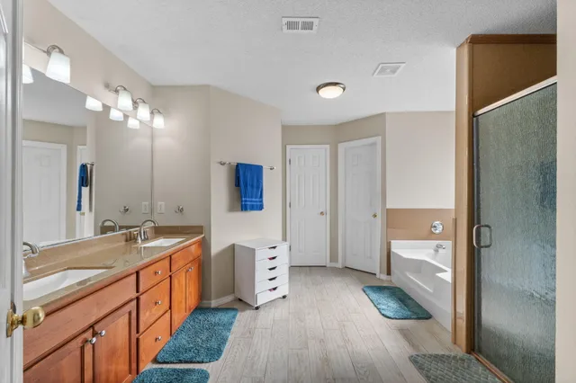 a bathroom with a sink a mirror and a shower