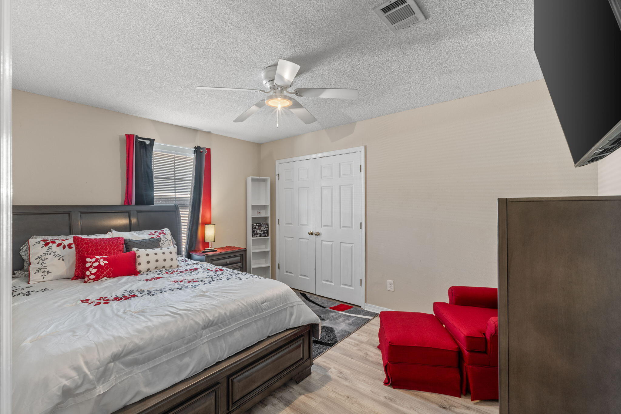 7036 Rampart Way Pensacola, FL 32505 - Photo 24 of 39 a bedroom with a bed and a chandelier