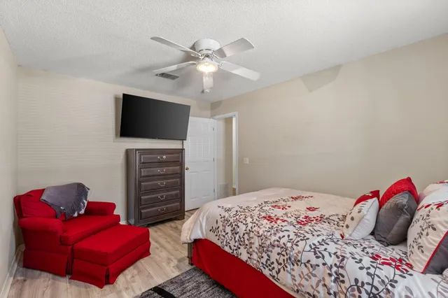 a bedroom with a bed and a television