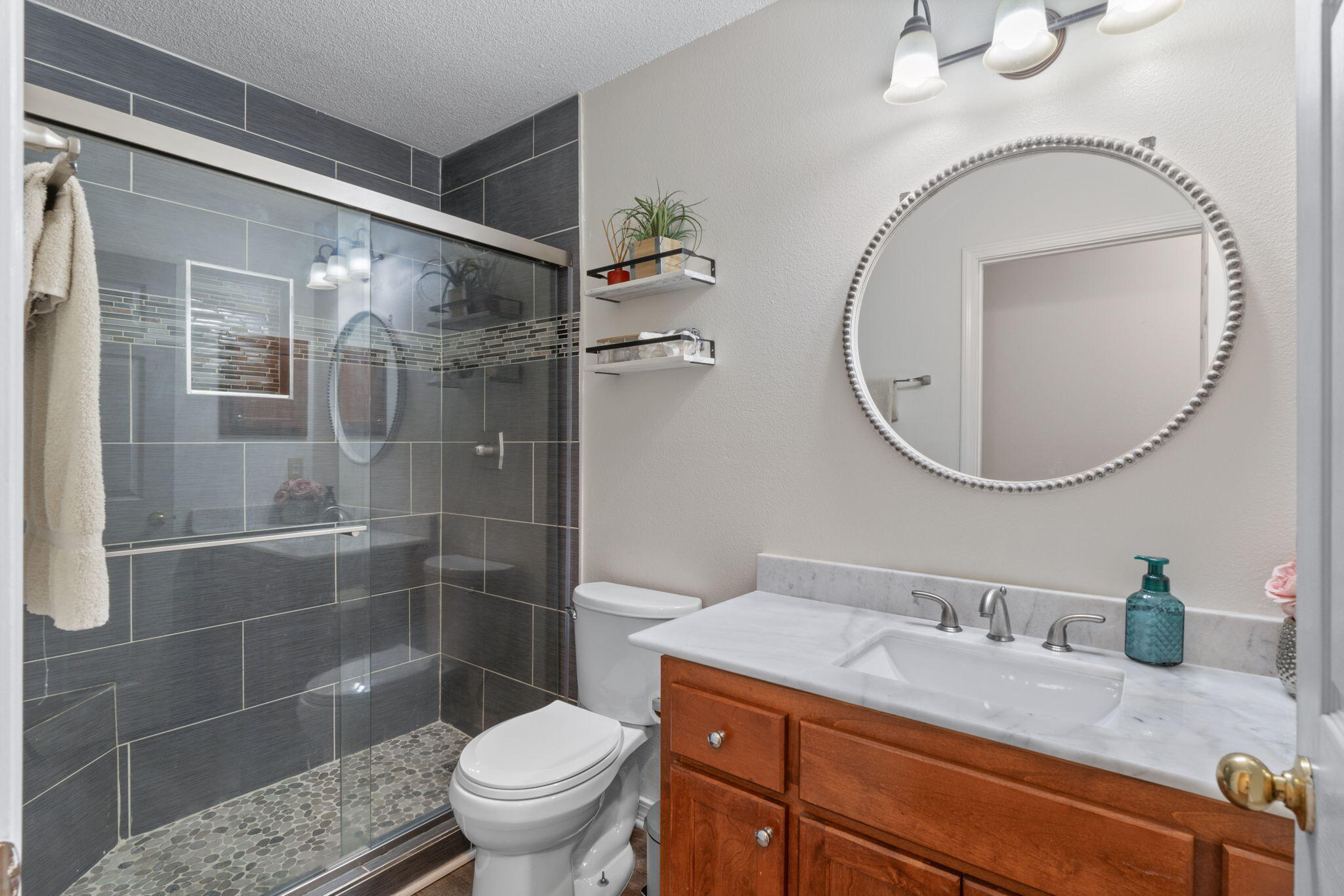 7036 Rampart Way Pensacola, FL 32505 - Photo 28 of 39 a bathroom with a granite countertop sink a toilet and a mirror