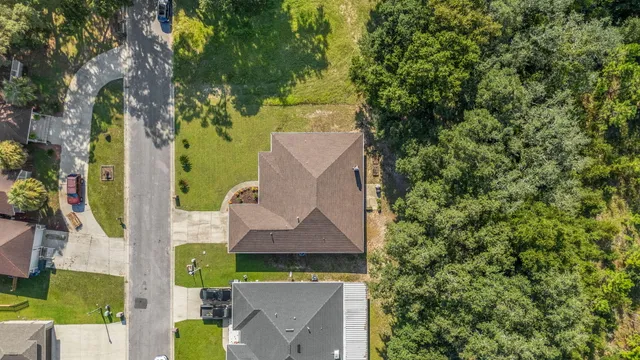 an aerial view of a house with swimming pool and garden space