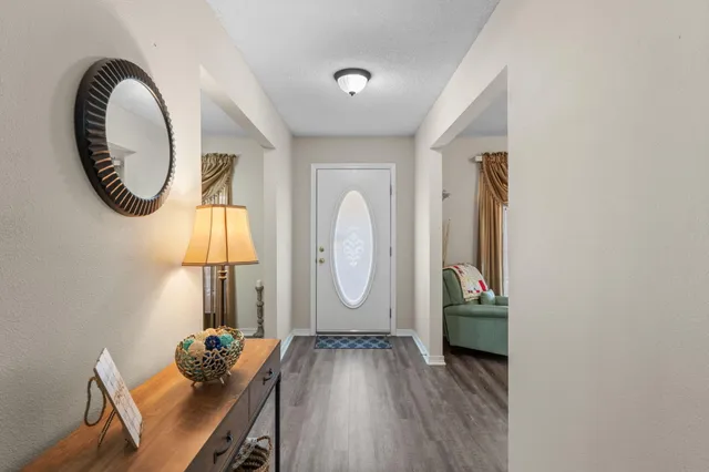 a room with wooden floor and a painting on the wall