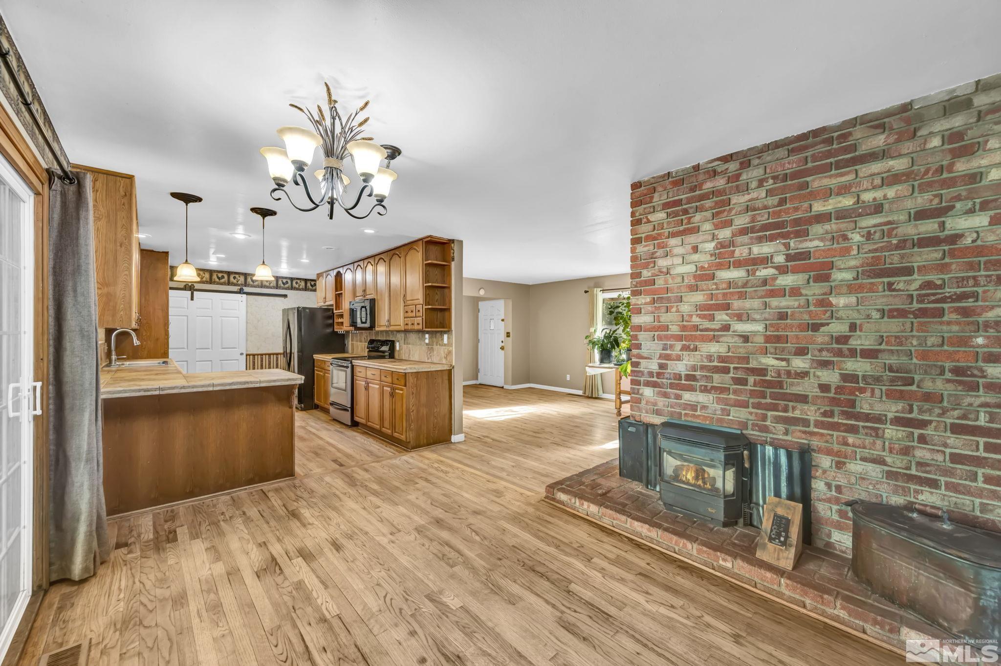 55 Surrey Drive Reno, NV 89521 - Photo 11 of 40 a open kitchen with cabinets a sink and stainless steel appliances