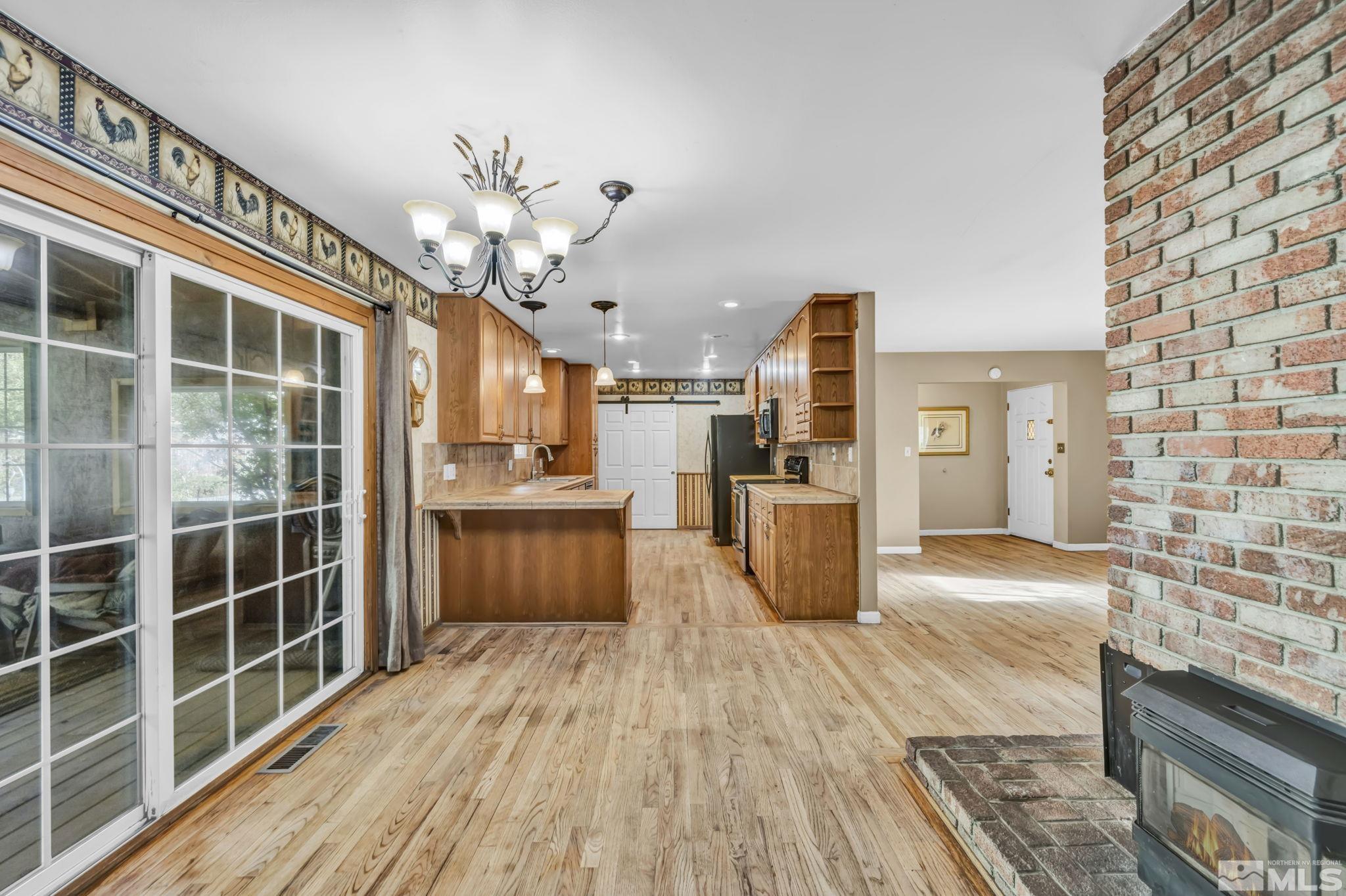 55 Surrey Drive Reno, NV 89521 - Photo 13 of 40 a view of a kitchen with wooden floor and a kitchen