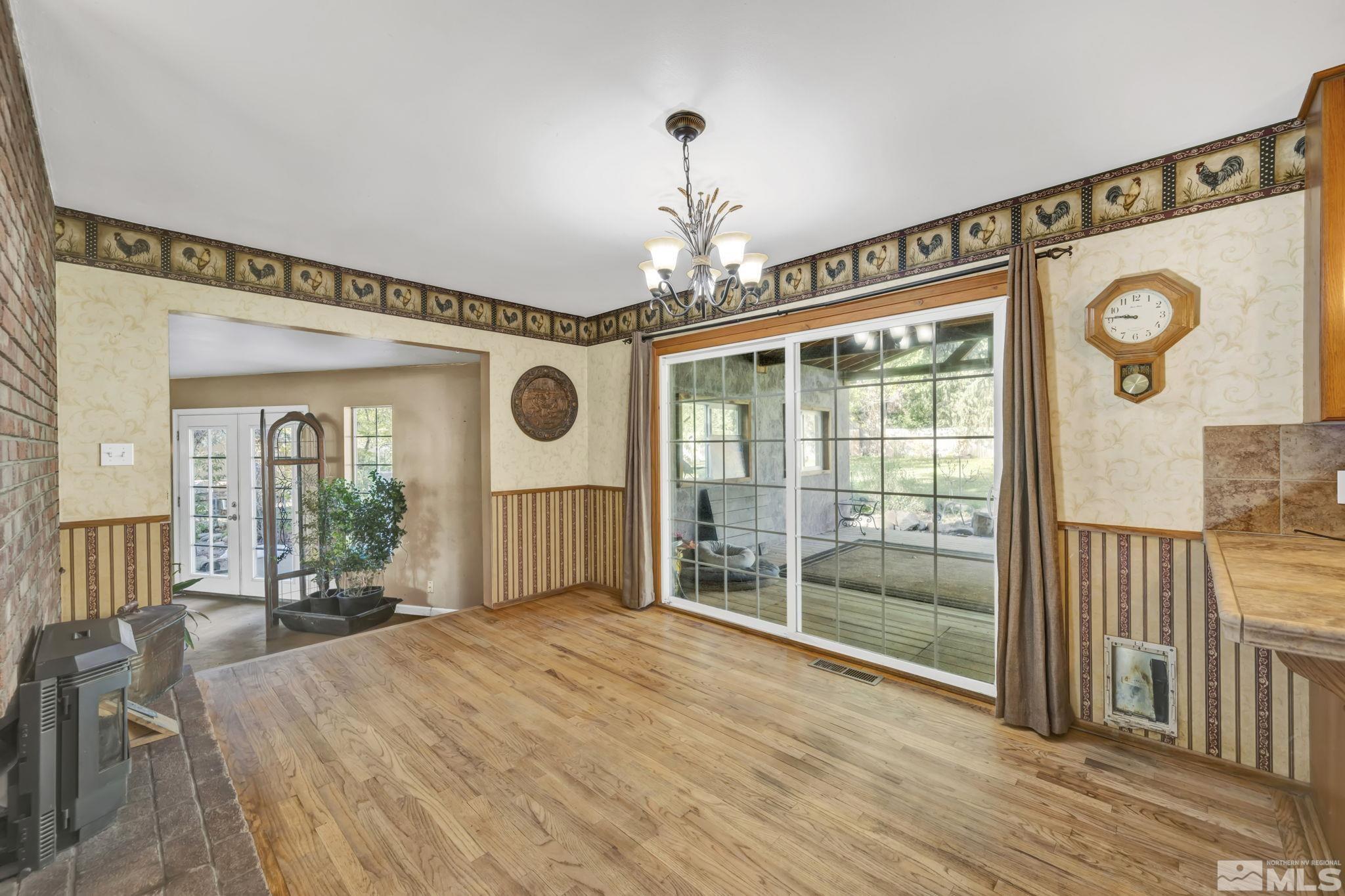 55 Surrey Drive Reno, NV 89521 - Photo 14 of 40 a spacious bedroom with a large bed and a chandelier