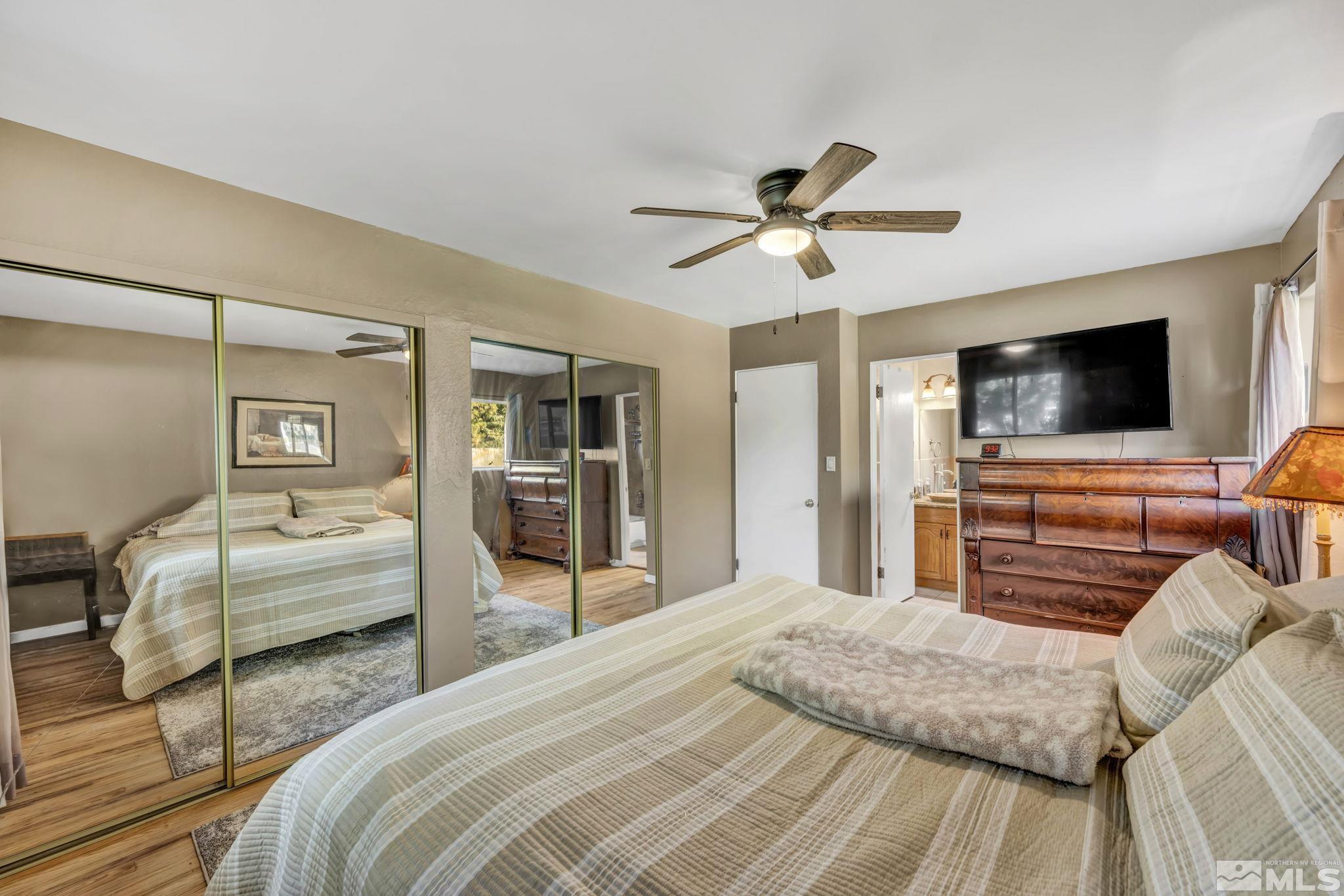 55 Surrey Drive Reno, NV 89521 - Photo 22 of 40 a bedroom with a bed and a flat screen tv