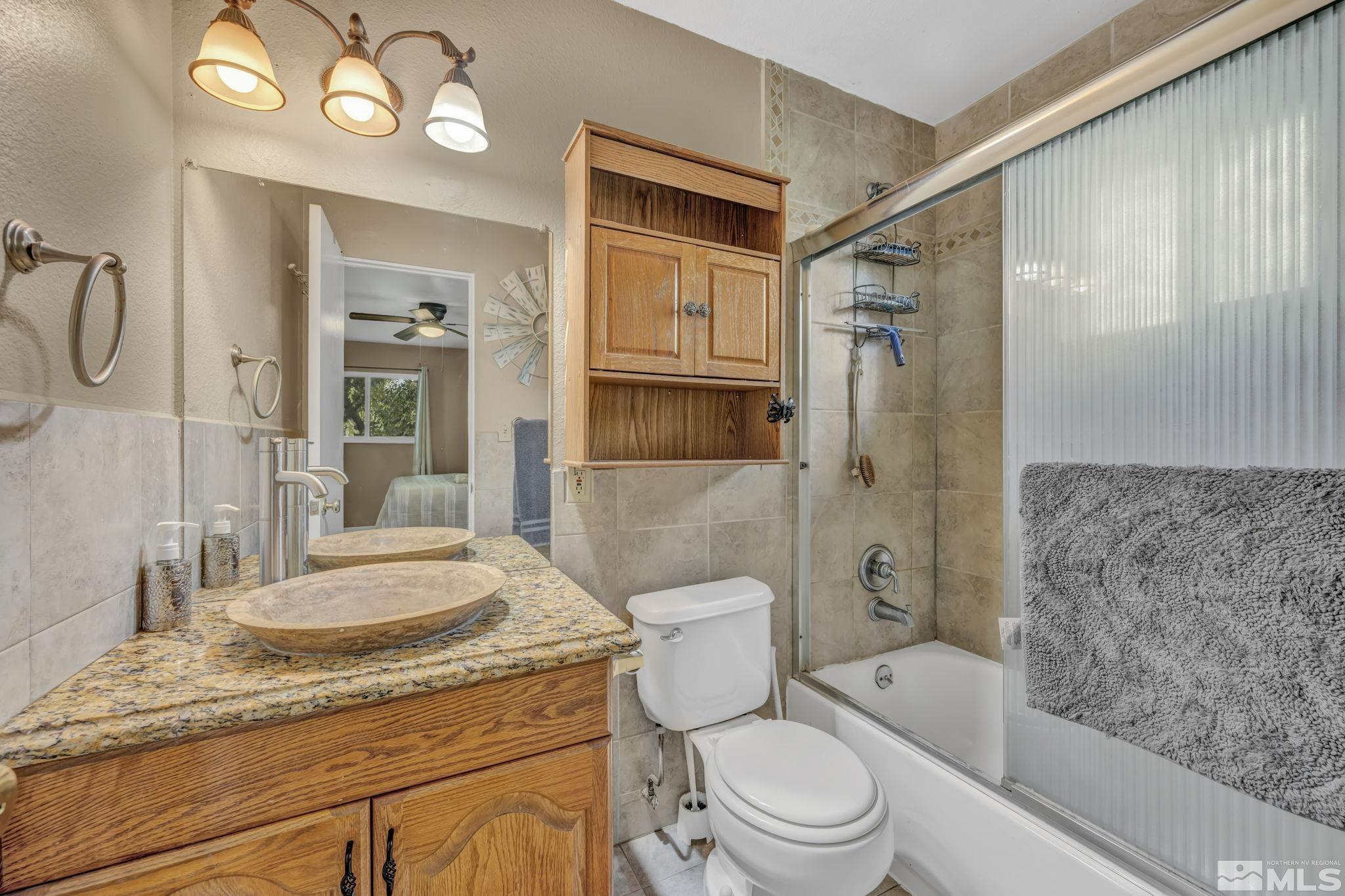 55 Surrey Drive Reno, NV 89521 - Photo 23 of 40 a bathroom with a granite countertop sink toilet and shower