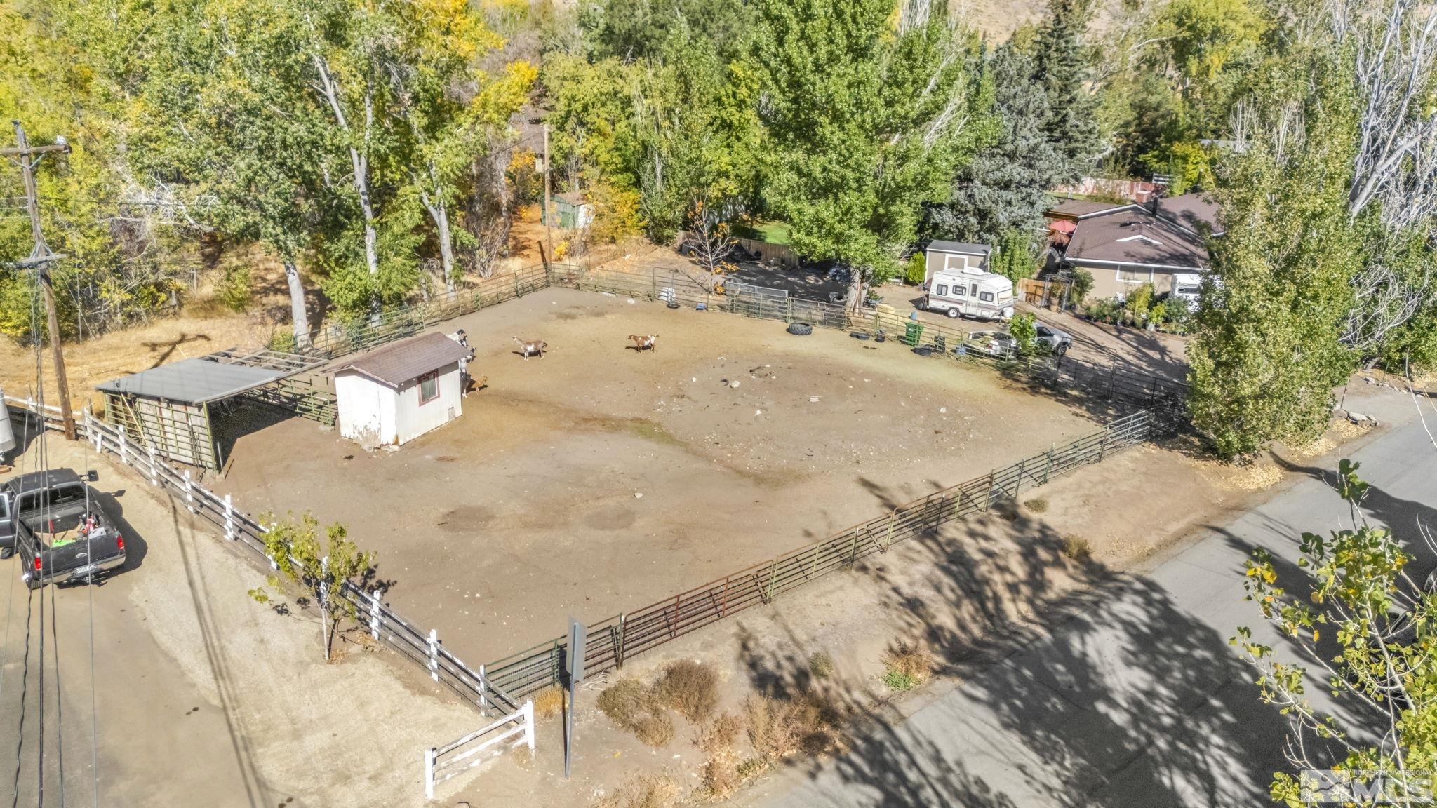 55 Surrey Drive Reno, NV 89521 - Photo 29 of 40 a backyard of a house with large trees and plants