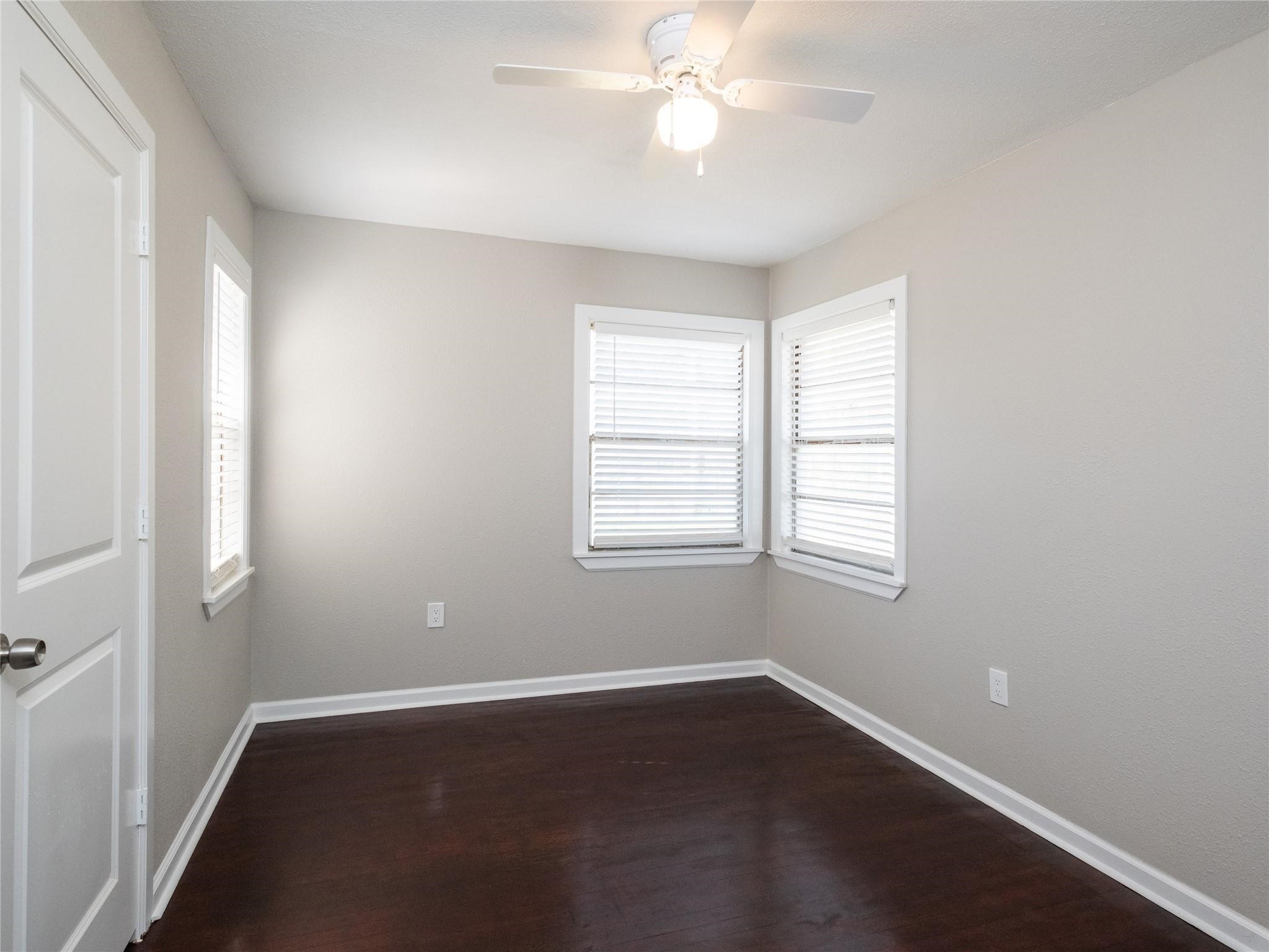 3215 Soway Street Houston, TX 77080 - Photo 11 of 29 a view of an empty room with wooden floor and a window