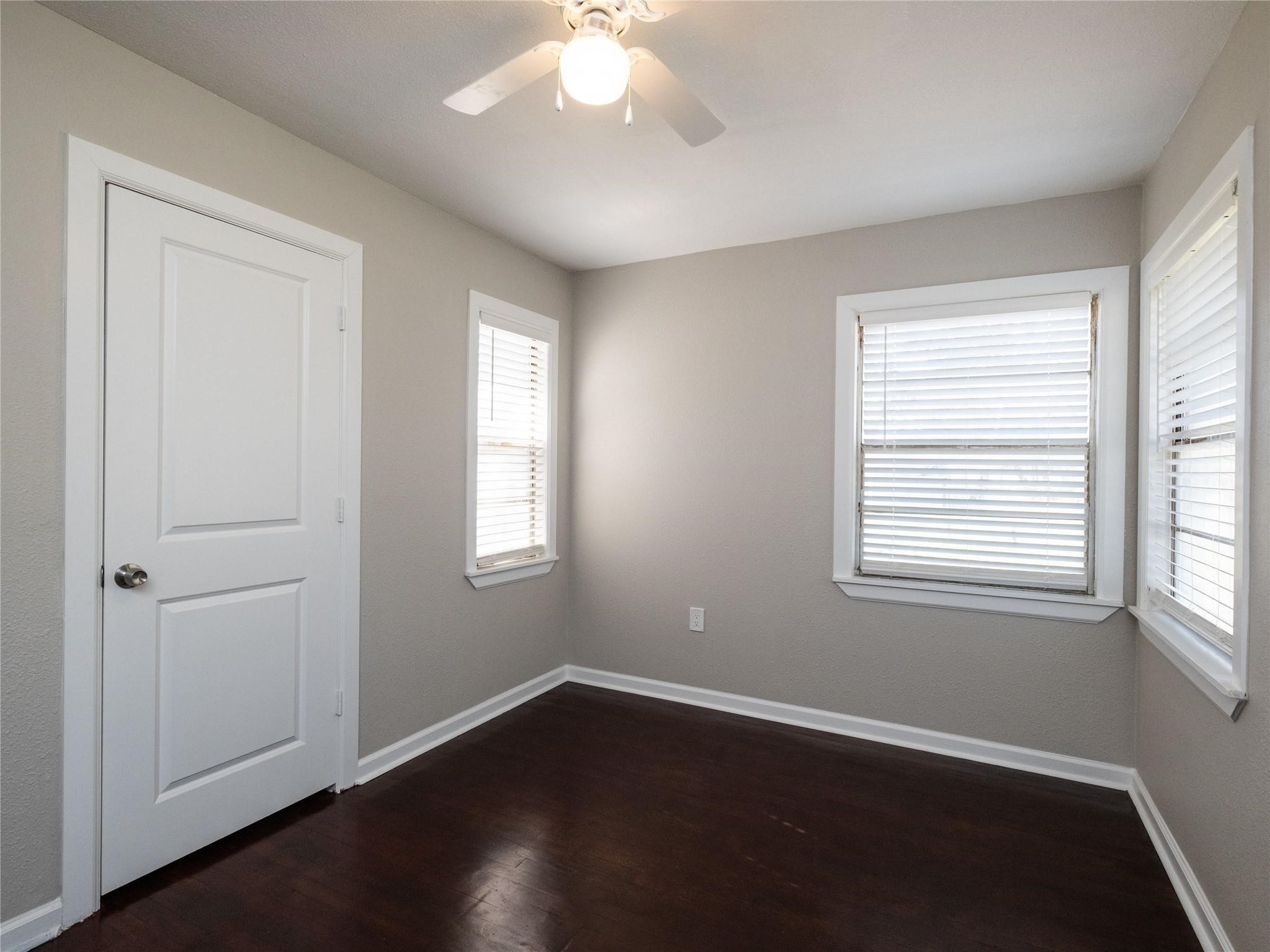 3215 Soway Street Houston, TX 77080 - Photo 12 of 29 an empty room with wooden floor and windows