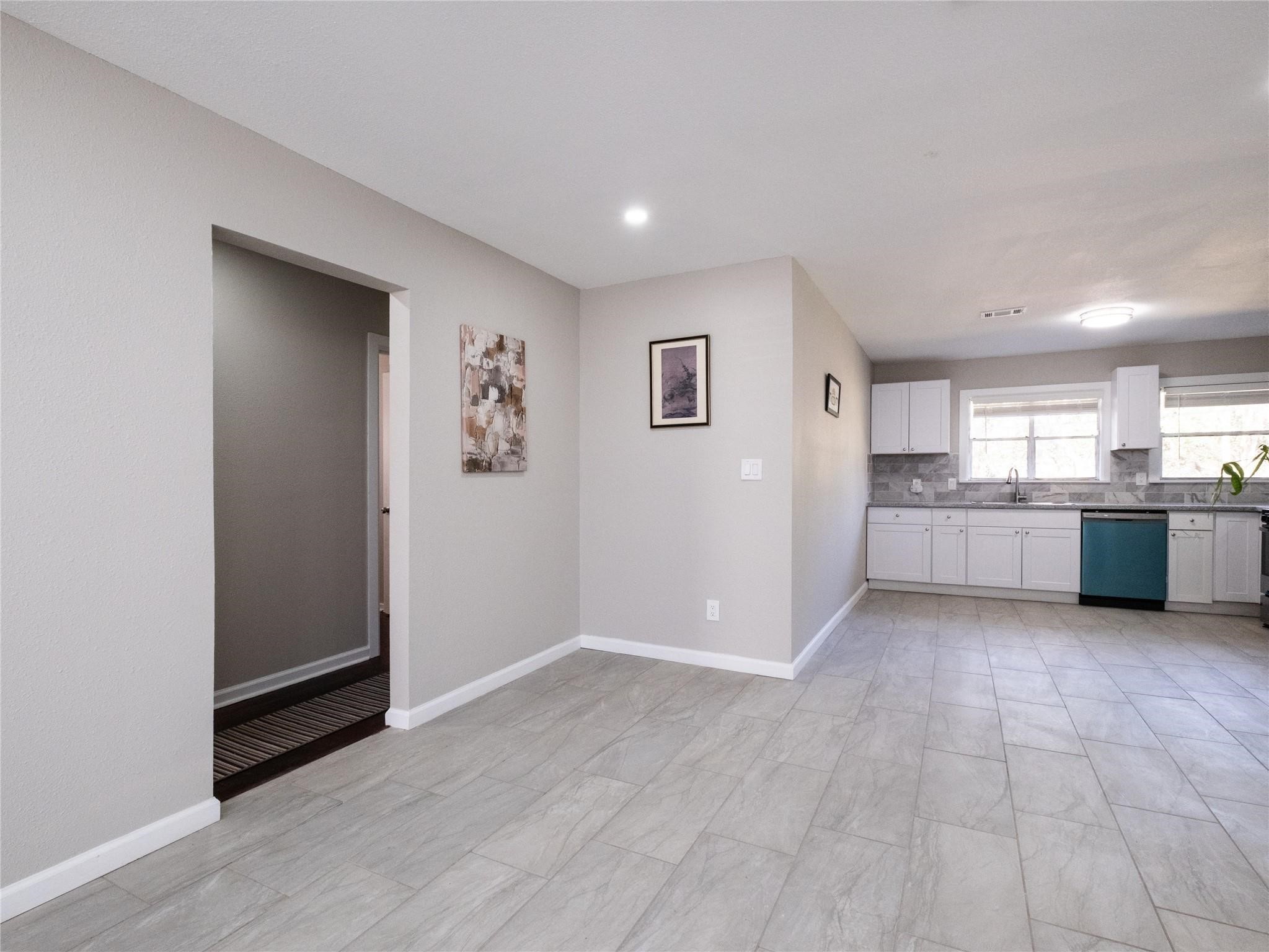 3215 Soway Street Houston, TX 77080 - Photo 17 of 29 a view of a kitchen with wooden floor and windows