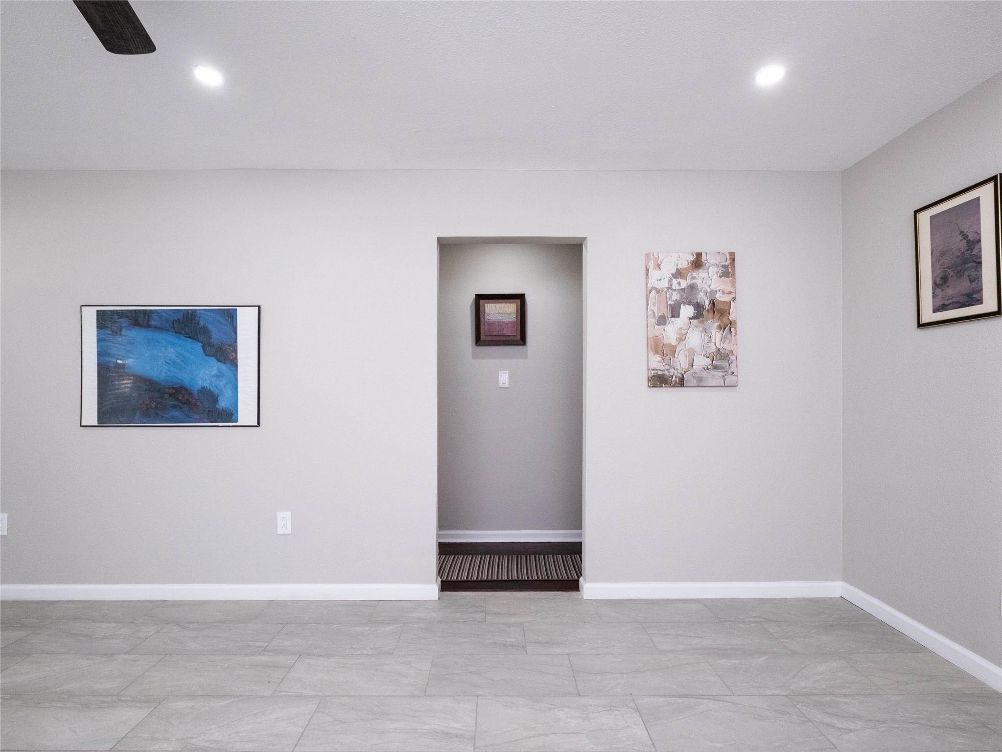 3215 Soway Street Houston, TX 77080 - Photo 18 of 29 an empty room with wall painting and windows