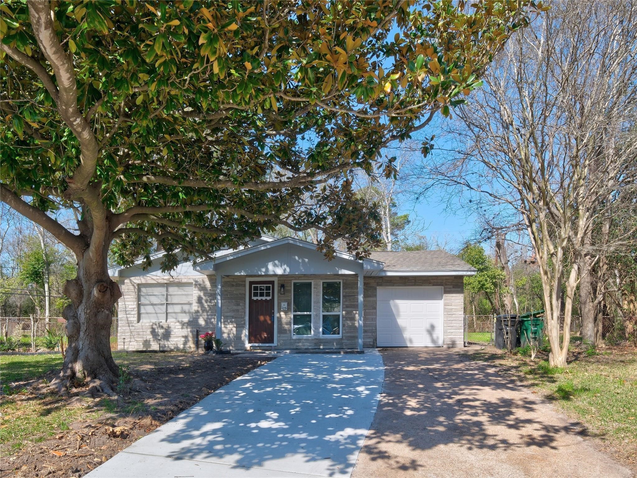 3215 Soway Street Houston, TX 77080 - Photo 23 of 29 a front view of a house with a garden