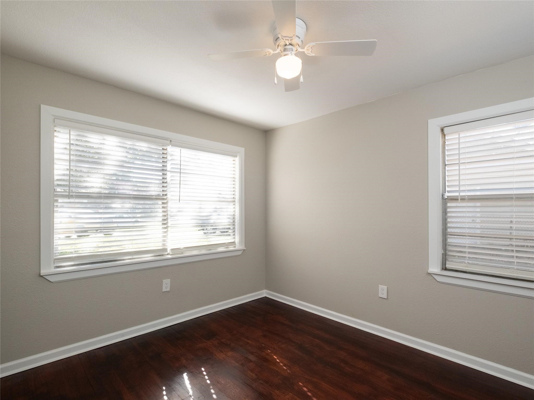 3215 Soway Street Houston, TX 77080 - Photo 6 of 29 a view of an empty room with wooden floor and a window