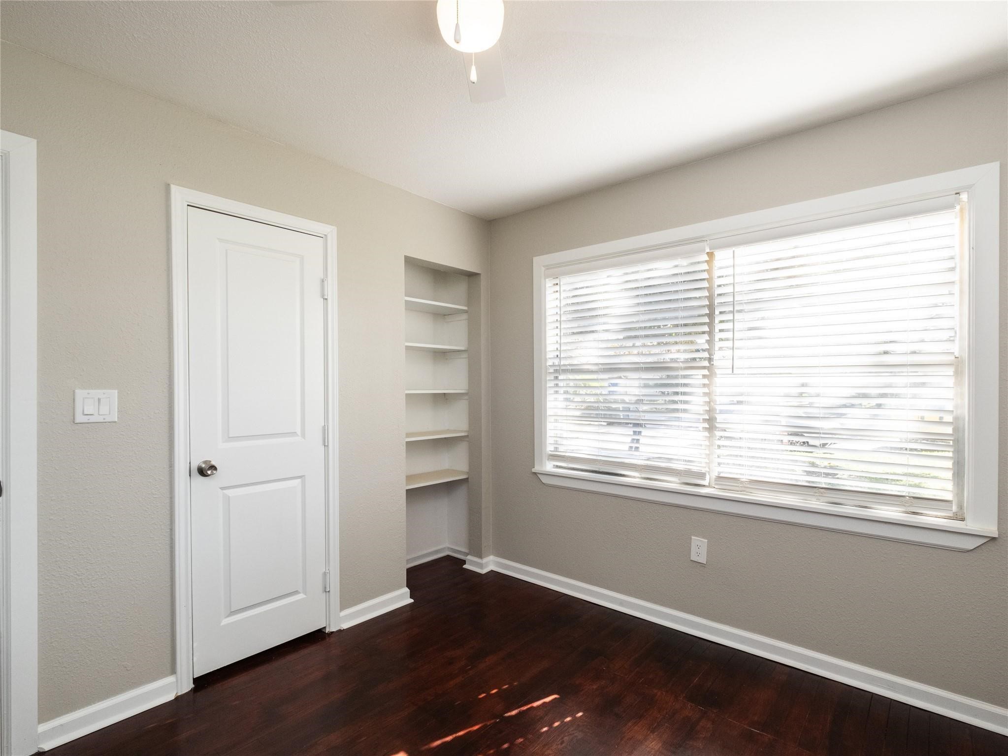 3215 Soway Street Houston, TX 77080 - Photo 7 of 29 a view of an empty room with a window and wooden floor