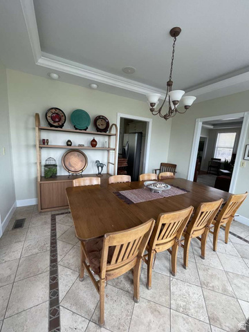 7030 West 2100 North Mendon, UT 84325 - Photo 23 of 67 Spacious interior room featuring tile flooring with a decorative inlay, crown molding, and a tray ceiling