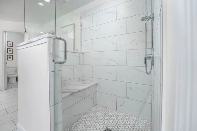 a bathroom with a sink toilet and window