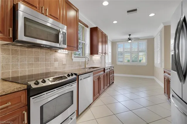 a kitchen with stainless steel appliances a stove sink microwave and cabinets