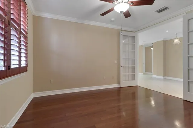 wooden floor in an empty room with a window