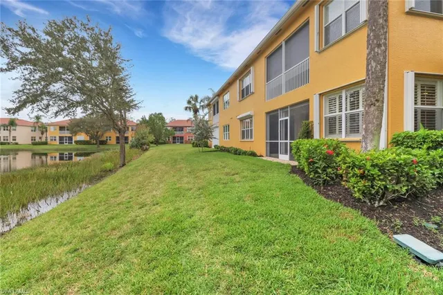 a view of a house with a yard and plants