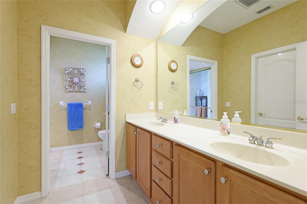 6103 Aviary Court Bradenton, FL 34203 - Photo 21 of 38 a spacious bathroom with a sink a mirror and a shower