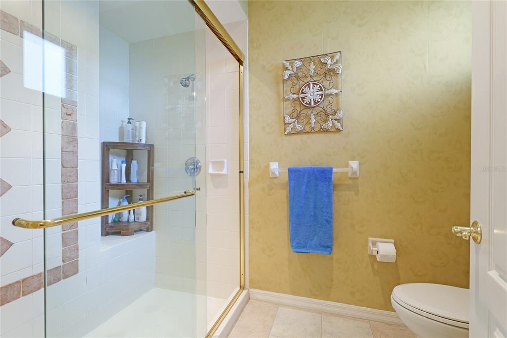 6103 Aviary Court Bradenton, FL 34203 - Photo 22 of 38 a bathroom with a toilet and a shower