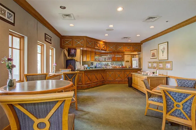 a dining room with stainless steel appliances kitchen island granite countertop a table and chairs
