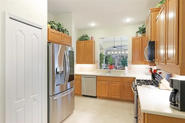 a kitchen with stainless steel appliances granite countertop a refrigerator and a sink
