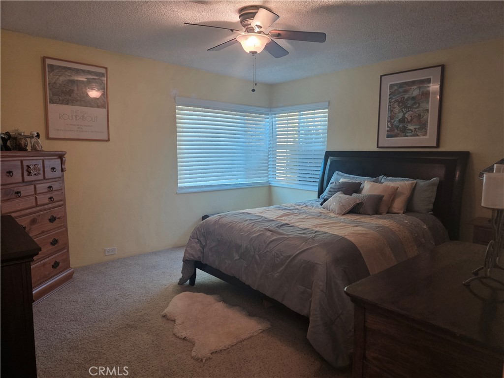 4504 Eickhoff Road Lakeport, CA 95453 - Photo 13 of 40 a bedroom with a bed and a chandelier