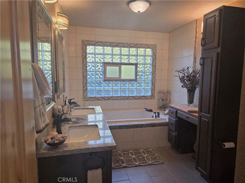 4504 Eickhoff Road Lakeport, CA 95453 - Photo 14 of 40 a bathroom with a tub sink and a mirror