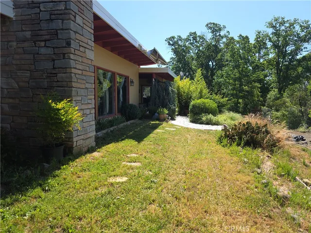 a view of backyard with a table and chairs and potted plants