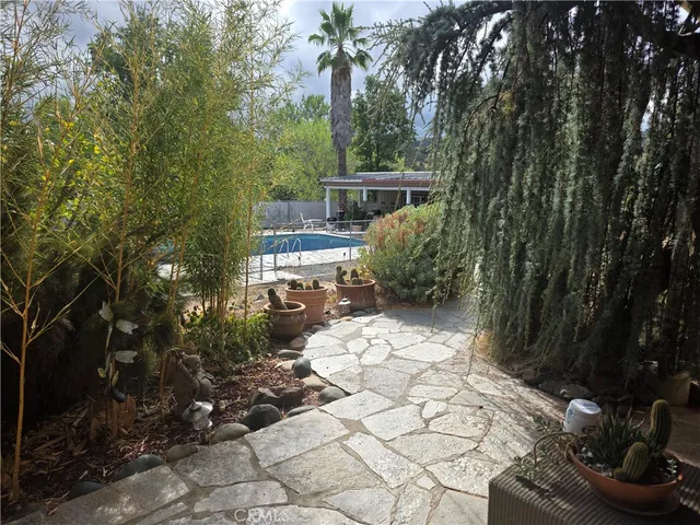 a view of a backyard with sitting area