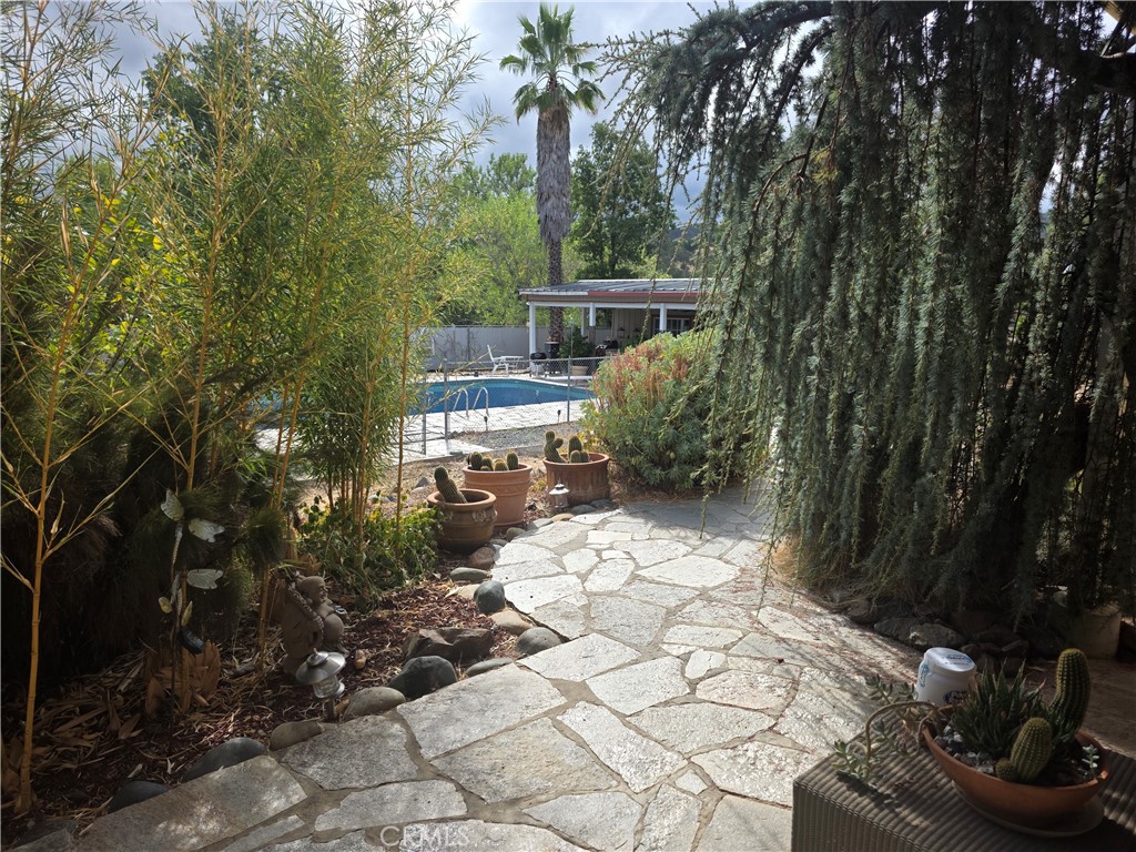 4504 Eickhoff Road Lakeport, CA 95453 - Photo 26 of 40 a view of backyard with a table and chairs and potted plants