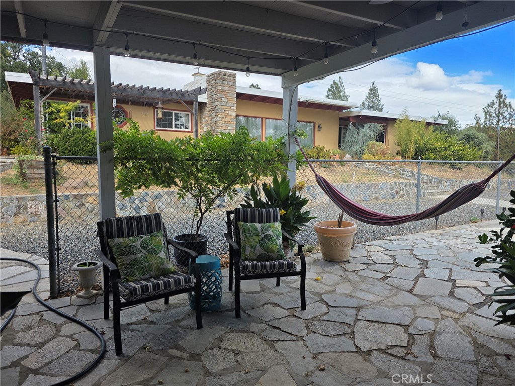 4504 Eickhoff Road Lakeport, CA 95453 - Photo 31 of 40 a view of a patio with table and chairs potted plants with wooden floor and fence