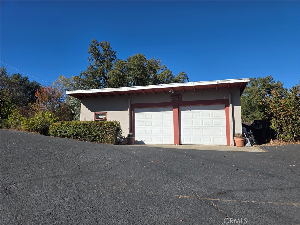 4504 Eickhoff Road Lakeport, CA 95453 - Photo 34 of 40 a view of a house with a yard and garage