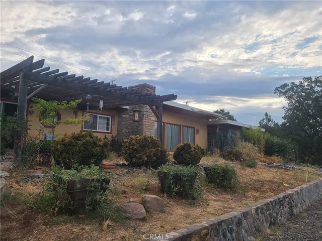 a view of a house with yard and sitting area