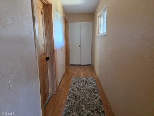 an empty room with a window and a ceiling fan