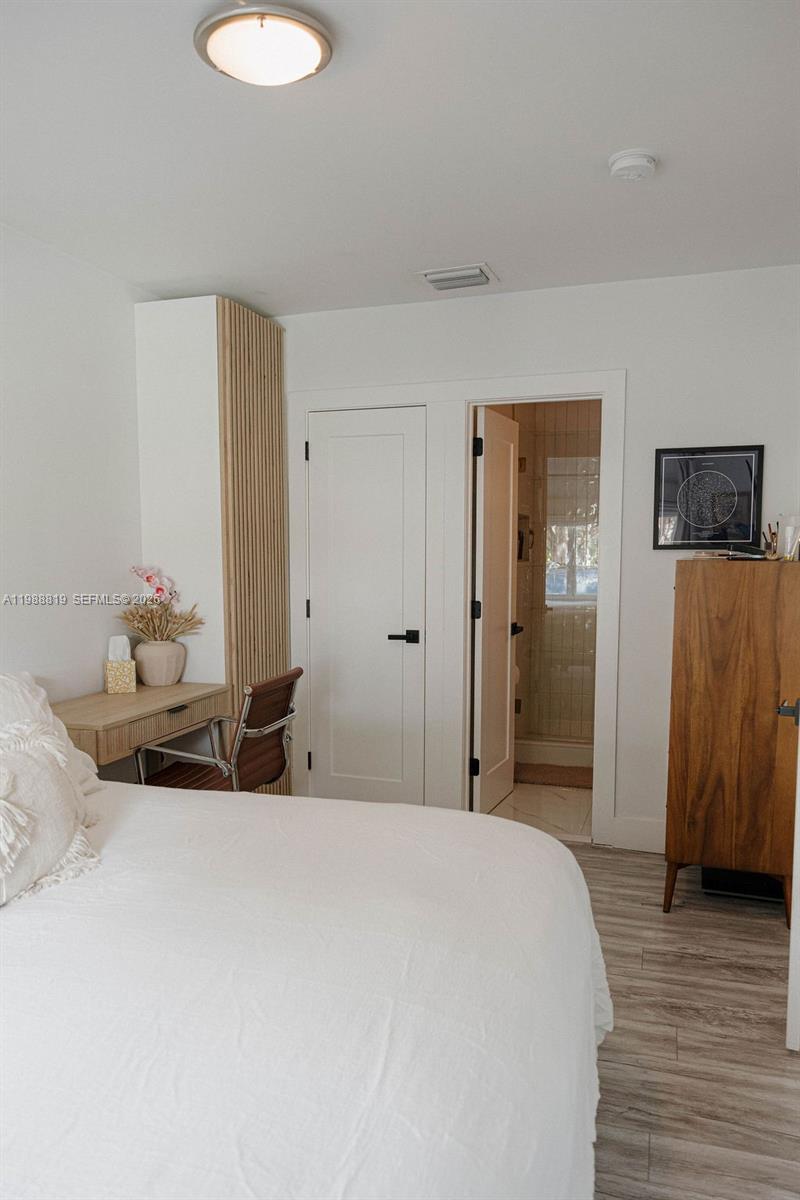3205 Southwest 68th Avenue Miami, FL 33155 - Photo 21 of 33 a bedroom with a bed and wooden floor