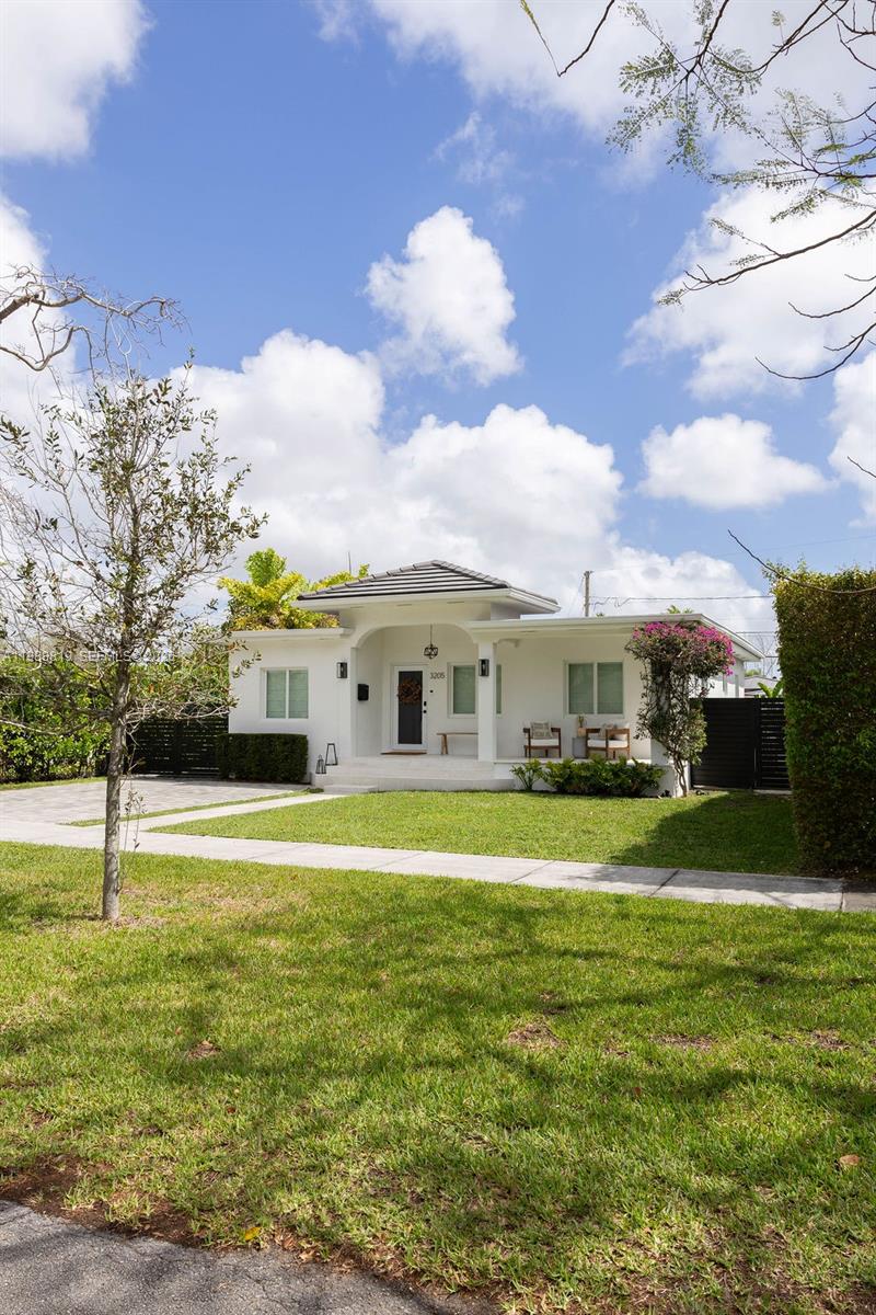 3205 Southwest 68th Avenue Miami, FL 33155 - Photo 3 of 33 a view of a big house with a big yard and a large tree
